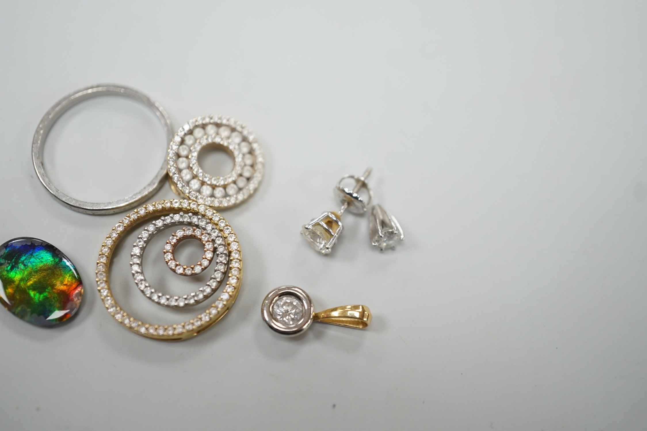 Two small circular 18k and diamond chip set pendants, largest 19mm, one other 18k and solitaire diamond pendant, a mounted diamond, a 14k and diamond ear stud approx. 0.25ct, a 'platinum 'band and one other item.